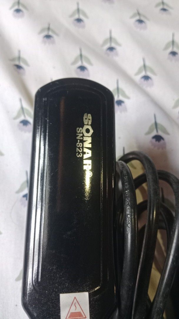 Sonar SN-823 and Sofitec Hair Straighteners (Category: Hair) located in San Miguel. Submitted by chriswajer65155 (Listing ID 1470944880, Image 2). Description: - Bundle of 3 black hair straighteners sold as a set - Includes Sonar SN-823 with a thick black body and warning symbol - Includes Sofitec model with a ribbed handle and white side accent - Includes a third flat iron featuring a white heating plate and cream-coloured power cord - All units