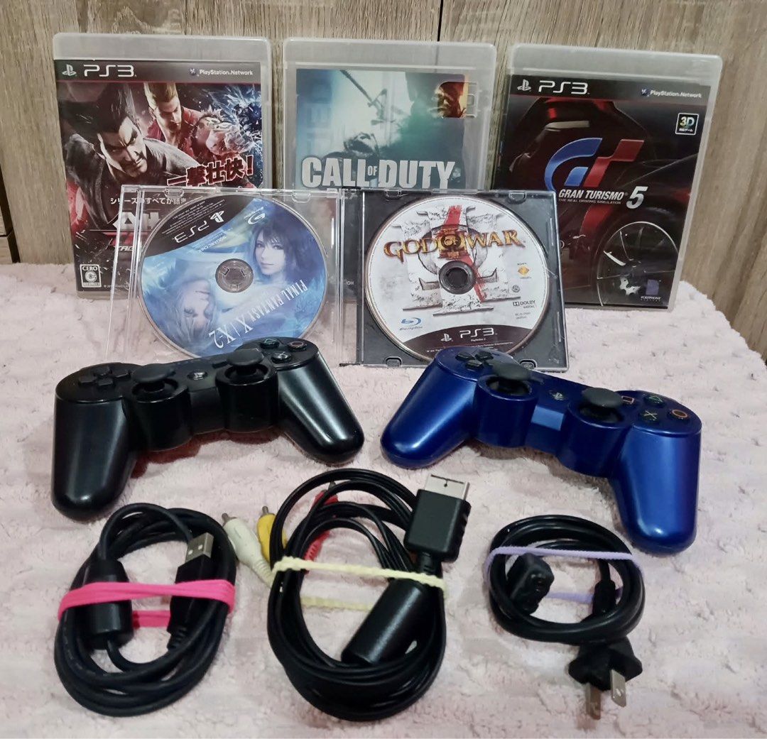 Sony PlayStation 3 Console with 2 Controllers and Games (Category: PlayStation) located in Davao. Submitted by anskirt26 (Listing ID 1471000083, Image 3). Description: - Sony PlayStation 3 console (ready to use) - 2 Wireless DualShock 3 controllers (1 Black, 1 Blue) - Complete cables: Power cable, AV cable, and charging cable - Included Games: Final Fantasy X/X-2 HD Remaster, Call of Duty, Gran Turismo 5, plus God of War III disc - Perfect all-in
