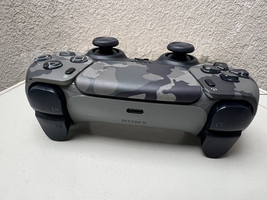 Sony PlayStation 5 DualSense Wireless Controller Gray Camouflage (Category: Controllers) located in Davao. Submitted by bnine.nine (Listing ID 1471046900, Image 3). Description: - Sony PS5 DualSense Wireless Controller - Gray Camouflage - USB-C charging port and bottom charging pins - In excellent condition.