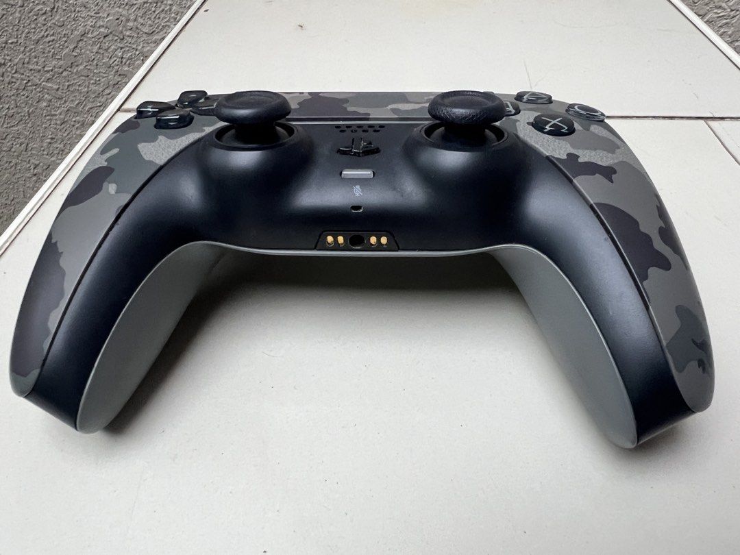 Sony PlayStation 5 DualSense Wireless Controller Gray Camouflage (Category: Controllers) located in Davao. Submitted by bnine.nine (Listing ID 1471046900, Image 2). Description: - Sony PS5 DualSense Wireless Controller - Gray Camouflage - USB-C charging port and bottom charging pins - In excellent condition.