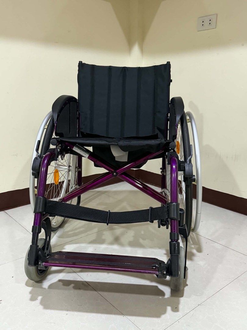 Sopur Purple Wheelchair Folding Mobility Aid (Category: Wheelchairs) located in Manila. Submitted by calmdolphin.87b0e4 (Listing ID 1470959947, Image 2). Description: - Brand: Sopur - Color: Vibrant purple frame with black upholstery - Portability: Foldable design for easy transport and storage - Mobility: Large rear wire wheels with handrims and reflectors, plus smooth front caster wheels - Comfort: Padded armrests and supportive backrest - Supp