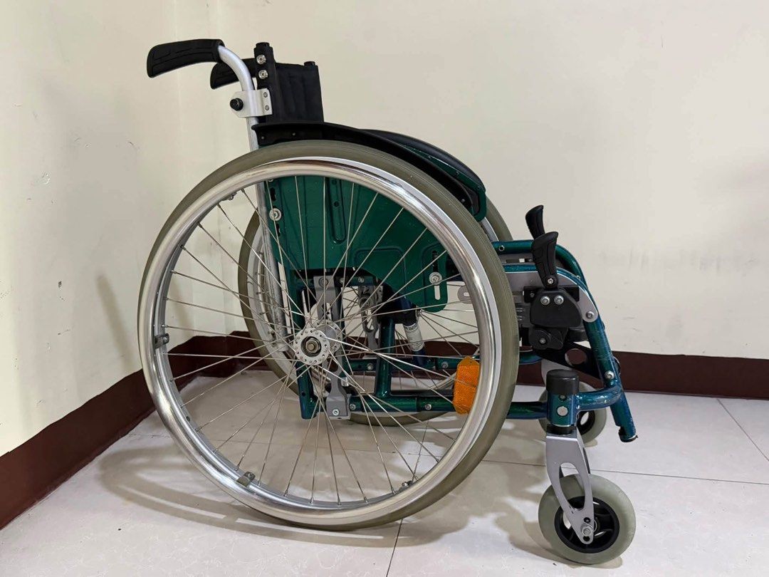 Sopur Youngster Wheelchair (Category: Wheelchairs) located in Manila. Submitted by calmdolphin.87b0e4 (Listing ID 1470957680, Image 3). Description: - Brand/Model: Sopur Youngster wheelchair - Color: Vibrant green and silver frame with black fabric seat and backrest - Portability: Foldable frame design for effortless transport and storage - Storage: Includes a handy storage bag attached to the back - Mobility & Safety: Manual push rims on large r