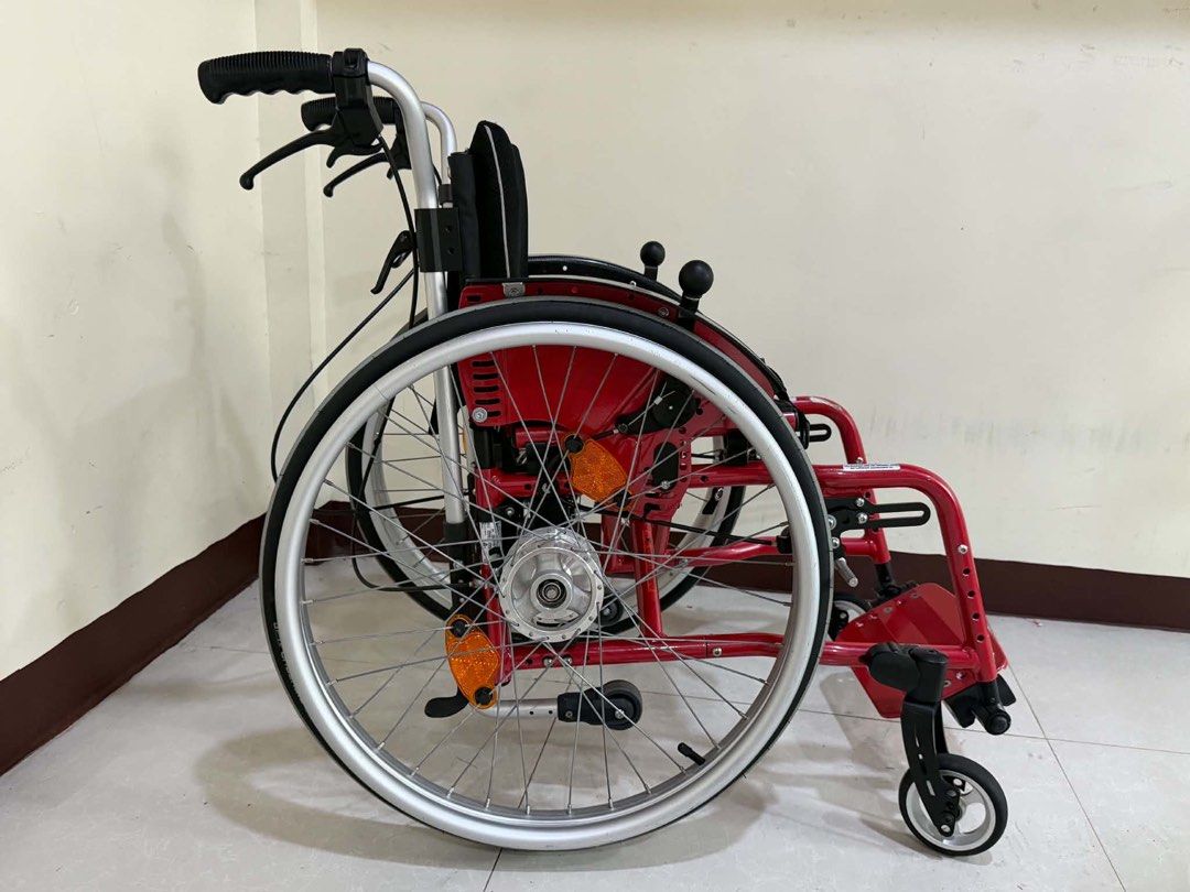 SORG Red Pediatric Wheelchair Mobility Aid (Category: Wheelchairs) located in Manila. Submitted by calmdolphin.87b0e4 (Listing ID 1470960135, Image 2). Description: - Brand: SORG pediatric wheelchair in eye-catching bright red - Mobility & Safety: Sturdy metal frame, smooth-swiveling front casters, and reliable attendant brakes - Wheels: Large spoked wheels with high-quality Schwalbe RightRun tires and orange reflectors - Comfort & Storage: Breat