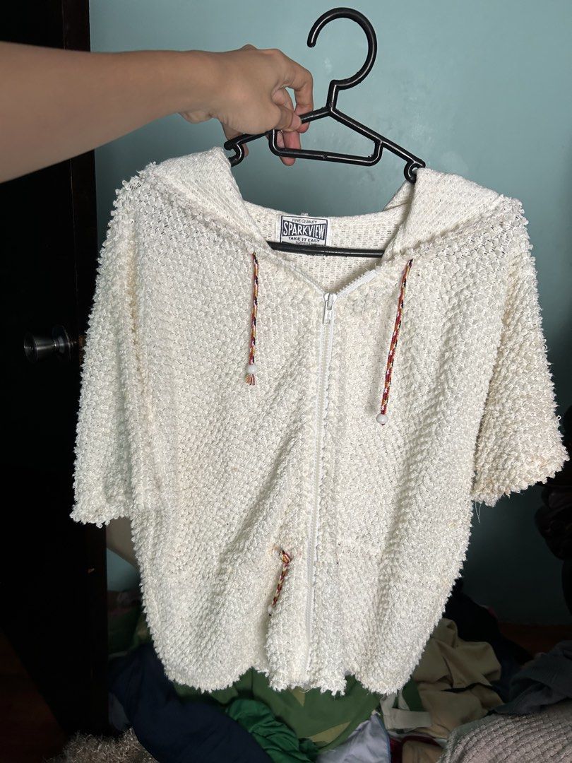 Sparkview White Textured Zip-Up Hoodie (Category: Hoodies) located in Manila. Submitted by lovely.453 (Listing ID 1470960526, Image 2). Description: - Brand/Style: Sparkview zip-up hoodie - Color/Material: Off-white textured knit - Design: Short sleeves, front zipper closure, attached hood - Details: Colorful braided drawstrings with white bead ends - Fit: Loose, relaxed fit - Use: Great casual layering piece.