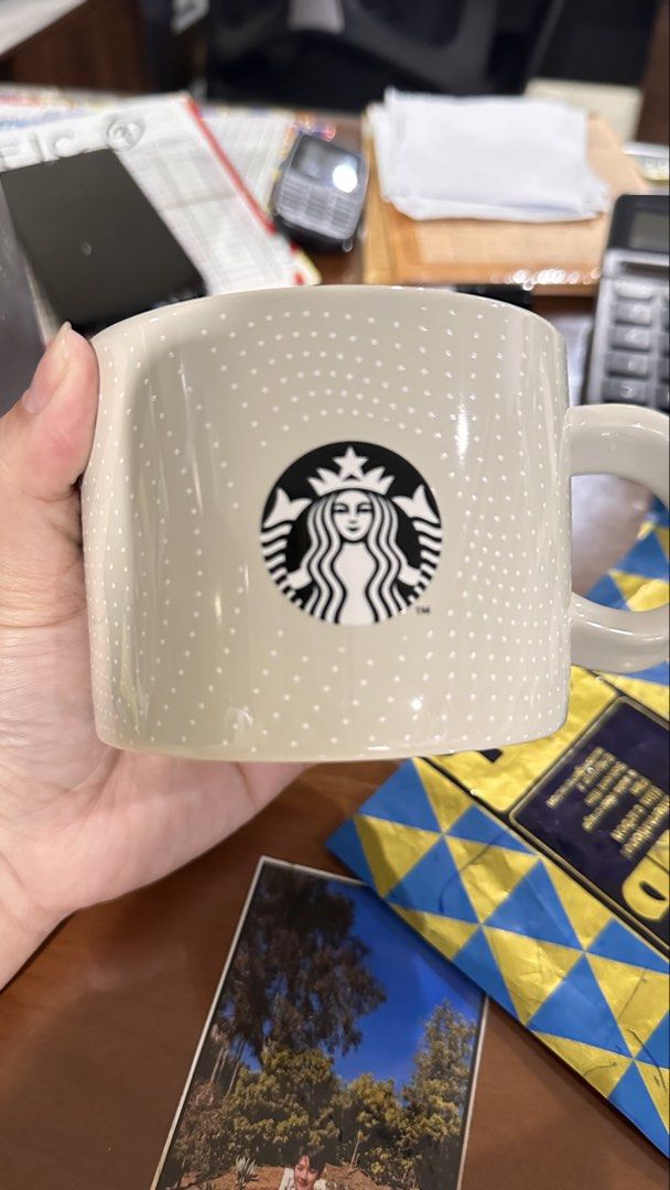 Starbucks Coffee Mug with Original Box (Category: Coffee & Tea Tableware) located in Manila. Submitted by dyelizabet65197 (Listing ID 1471002855, Image 2). Description: - Authentic Starbucks ceramic mug in a stylish neutral tone - Features playful white polka dots and the iconic siren logo on the front - Perfect capacity for your daily morning coffee, tea, or favorite beverage - Includes a matching black branded gift box with perforated lines - P