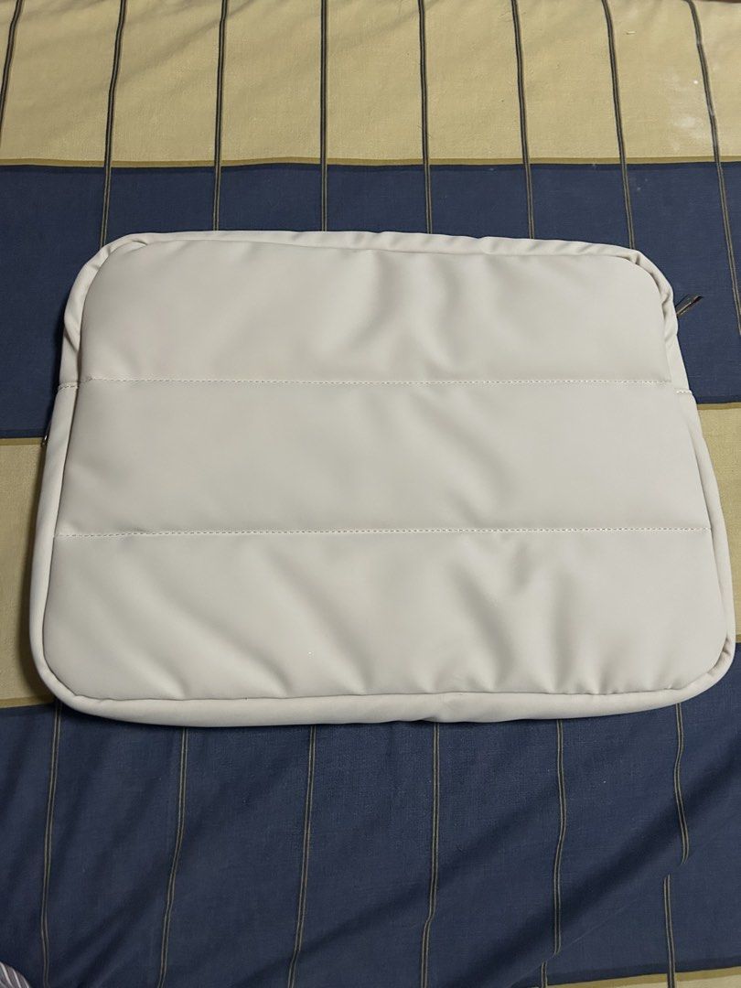 Straightforward 16 inch laptop sleeve (Category: Laptop Bags & Sleeves) located in Manila. Submitted by vasthorse-11b538 (Listing ID 1471065315, Image 2). Description: - Brand: Marta laptop sleeve - Color: NR chai - Design: Chic quilted exterior with a secure zippered top - Interior: Soft inner lining with an accessory pocket and elastic band - Condition: Brand new with label attached in original protective plastic packaging.
