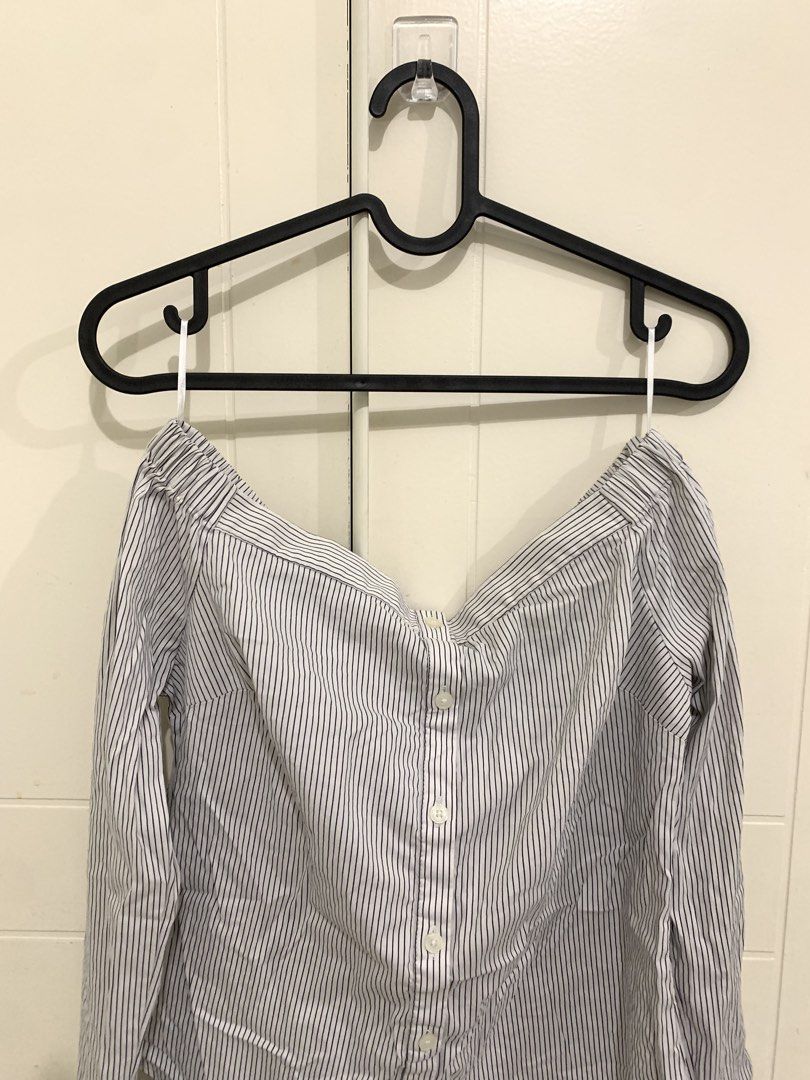 Striped Off-Shoulder Long Sleeve Top (Category: Longsleeves) located in Pasig City. Submitted by lovedbyri (Listing ID 1470956566, Image 2). Description: - Size: XS - Pattern: Black and white vertical stripes - Style: Off-shoulder neckline with elastic band, button-down front closure - Sleeves: Long sleeves with buttoned cuffs - Material: Lightweight cotton - Origin: Made in the Philippines - Occasion: Perfect for casual outings or office wear.