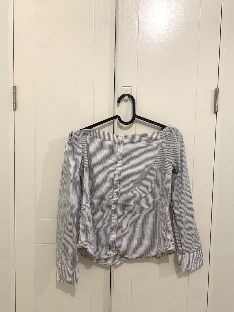 Striped Off-Shoulder Long Sleeve Top (Category: Longsleeves) located in Pasig City. Submitted by lovedbyri (Listing ID 1470956566, Image 1). Description: - Size: XS - Pattern: Black and white vertical stripes - Style: Off-shoulder neckline with elastic band, button-down front closure - Sleeves: Long sleeves with buttoned cuffs - Material: Lightweight cotton - Origin: Made in the Philippines - Occasion: Perfect for casual outings or office wear.