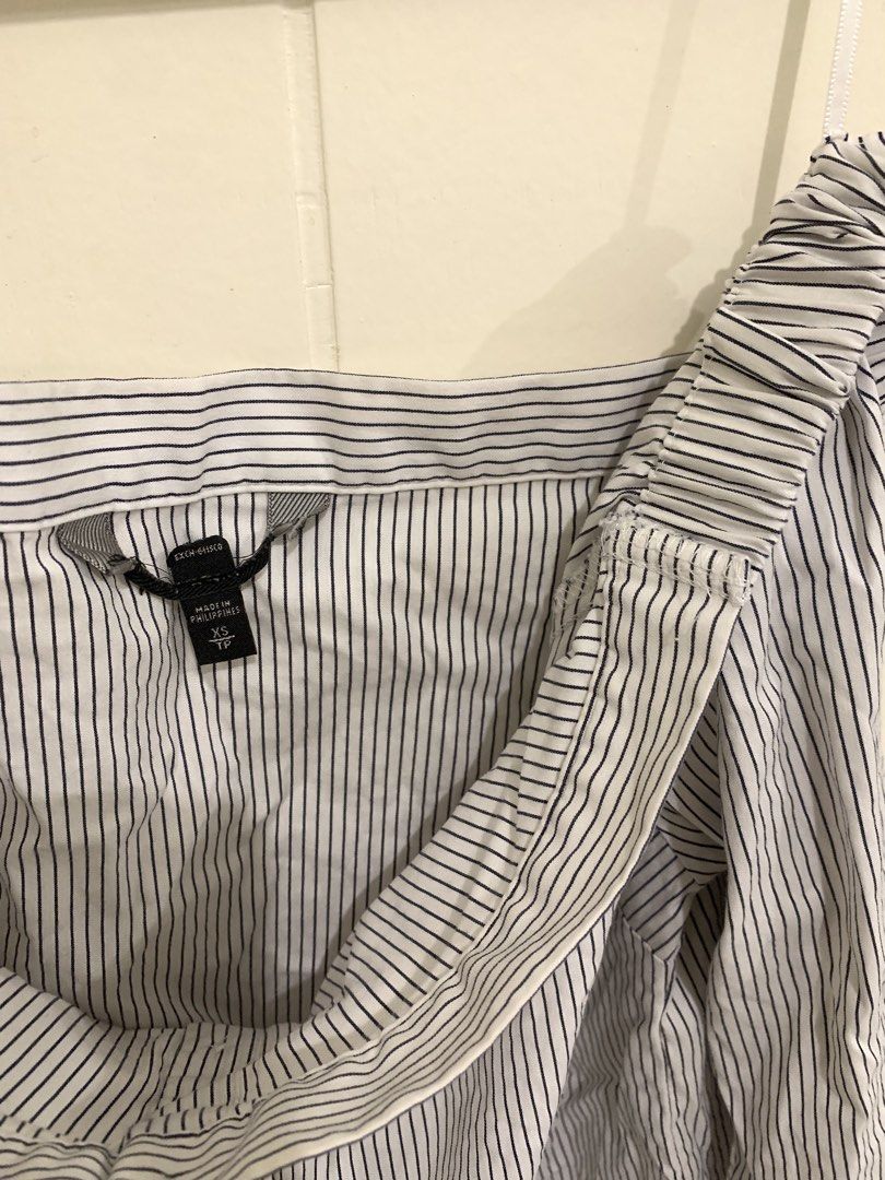 Striped Off-Shoulder Long Sleeve Top (Category: Longsleeves) located in Pasig City. Submitted by lovedbyri (Listing ID 1470956566, Image 3). Description: - Size: XS - Pattern: Black and white vertical stripes - Style: Off-shoulder neckline with elastic band, button-down front closure - Sleeves: Long sleeves with buttoned cuffs - Material: Lightweight cotton - Origin: Made in the Philippines - Occasion: Perfect for casual outings or office wear.