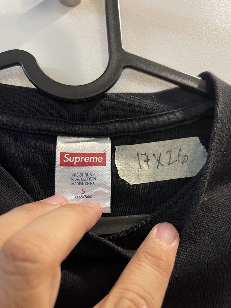 Supreme Flag Black Tee Size S (Category: Tshirts & Polo Shirts ) located in San Fernando. Submitted by bondocmac42825 (Listing ID 1470964640, Image 3). Description: - Brand: Supreme - Color: Solid black with clean collar - Size: Small (approx. 17" width x 26" length) - Design: Chest graphic featuring a blue flag and red box logo - Material: 100% pre-shrunk cotton (Made in China) - Condition: Excellent, well-maintained - Care: Interior tag with wa