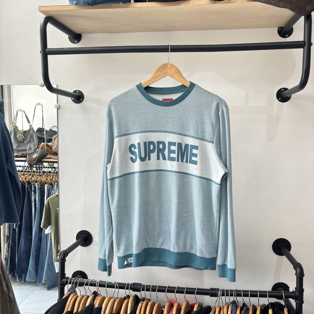 Supreme Panel Striped Long Sleeve Crewneck (Category: Coats, Jackets and Outerwear) located in Bambang. Submitted by heats777 (Listing ID 1471039459, Image 2). Description: - Brand: Supreme - Style: Crewneck sweater with large chest logo - Colorway: Light blue and dark teal - Size: Medium (includes red box logo neck tag) - Material: Cotton-polyester blend - Origin: Made in China - Condition: Excellent, carefully stored - Shipping: Fast ship natio