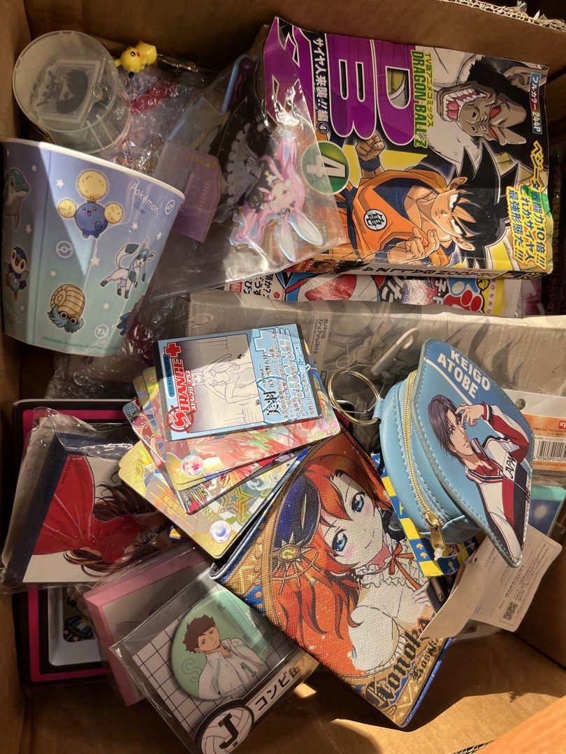 Take All Assorted Anime Merchandise Collection Lot (Category: Designer & Blind Box Toys) located in Gapan. Submitted by lunashop14 (Listing ID 1471089606, Image 3). Description: Massive collection of anime and manga goods. Includes art prints, Dragon Ball Z and Doraemon books, Pokémon cup, trading card games, card sleeves, keychains, pins, and pouches from various series like Prince of Tennis and Haikyuu. Variety of items, mostly unopened or in p