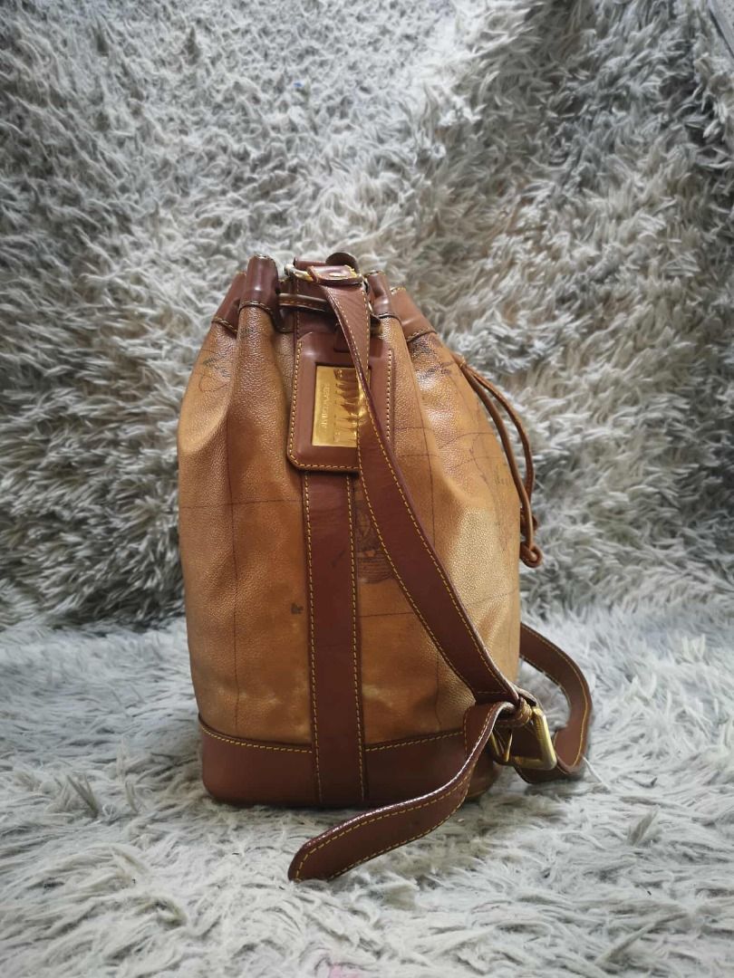 Tan Brown Vintage Map Print Drawstring Bucket Shoulder Bag (Category: Cross-body Bags) located in Santa Cruz. Submitted by jmy_surplus.2 (Listing ID 1471015960, Image 3). Description: Color: Tan Brown / Cognac Brown Type/Kind: Bucket Bag / Shoulder Bag / Drawstring Handbag Material: Body: Coated Canvas / Synthetic Leather (estimated) Handles & Trim: Leather-Look Material Lining: Fabric Hardware: Gold-Tone Metal Style: Vintage Classic Retro Casual