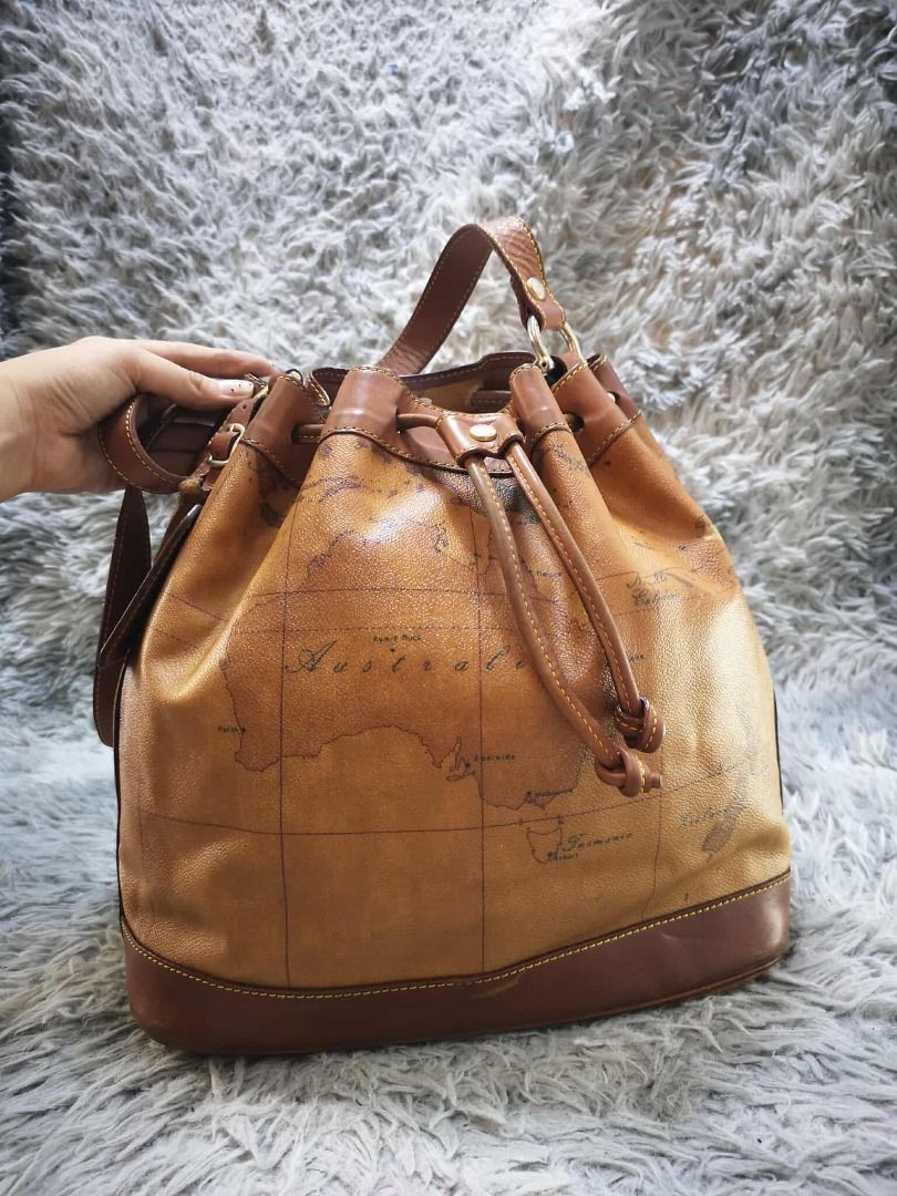 Tan Brown Vintage Map Print Drawstring Bucket Shoulder Bag (Category: Cross-body Bags) located in Santa Cruz. Submitted by jmy_surplus.2 (Listing ID 1471015960, Image 2). Description: Color: Tan Brown / Cognac Brown Type/Kind: Bucket Bag / Shoulder Bag / Drawstring Handbag Material: Body: Coated Canvas / Synthetic Leather (estimated) Handles & Trim: Leather-Look Material Lining: Fabric Hardware: Gold-Tone Metal Style: Vintage Classic Retro Casual