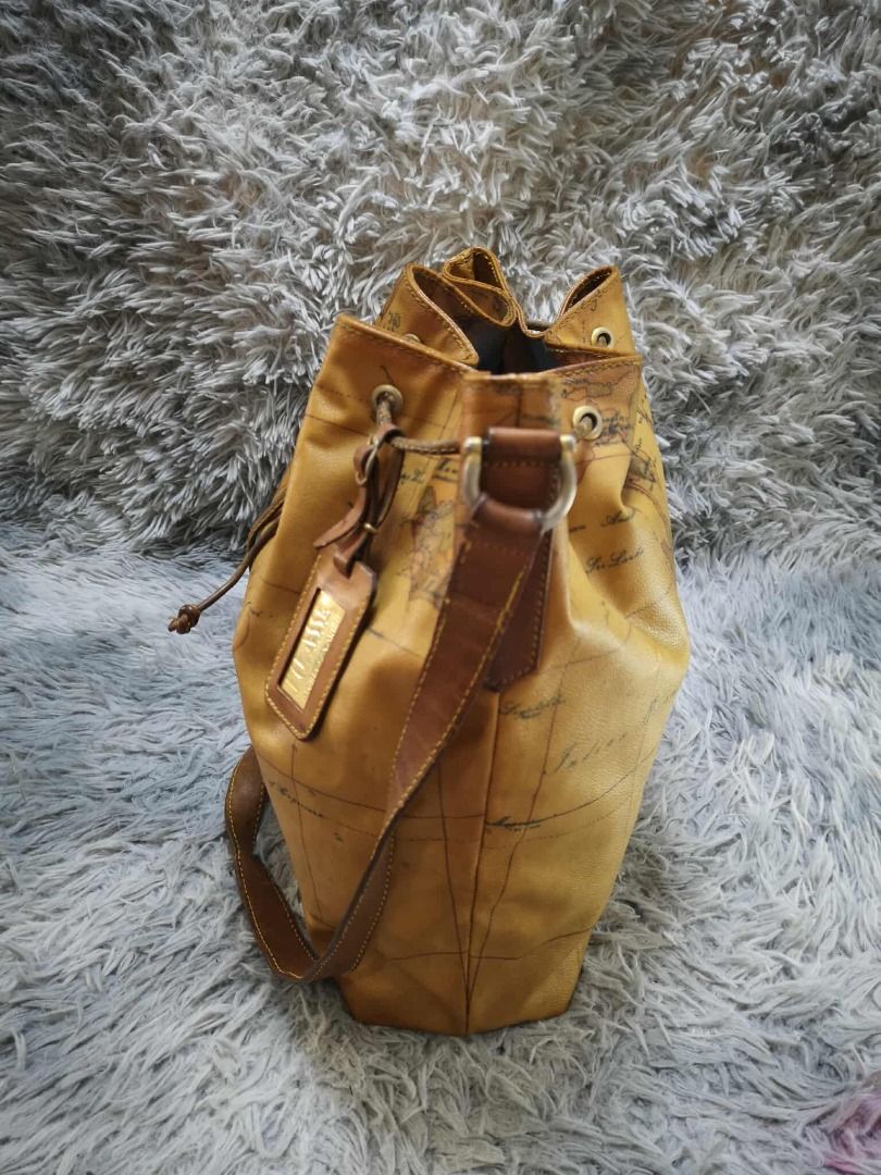 Tan Brown Vintage World Map Print Drawstring Bucket Bag (Category: Cross-body Bags) located in Santa Cruz. Submitted by jmy_surplus.2 (Listing ID 1471016164, Image 3). Description: Color: Tan Brown / Camel Brown Type/Kind: Bucket Bag / Crossbody Bag / Shoulder Bag Material: Body: Coated Canvas / Synthetic Leather (estimated) Strap & Trim: Leather-Look Material Lining: Fabric Hardware: Antique Gold-Tone Metal Style: Vintage Classic Retro Casual Tr