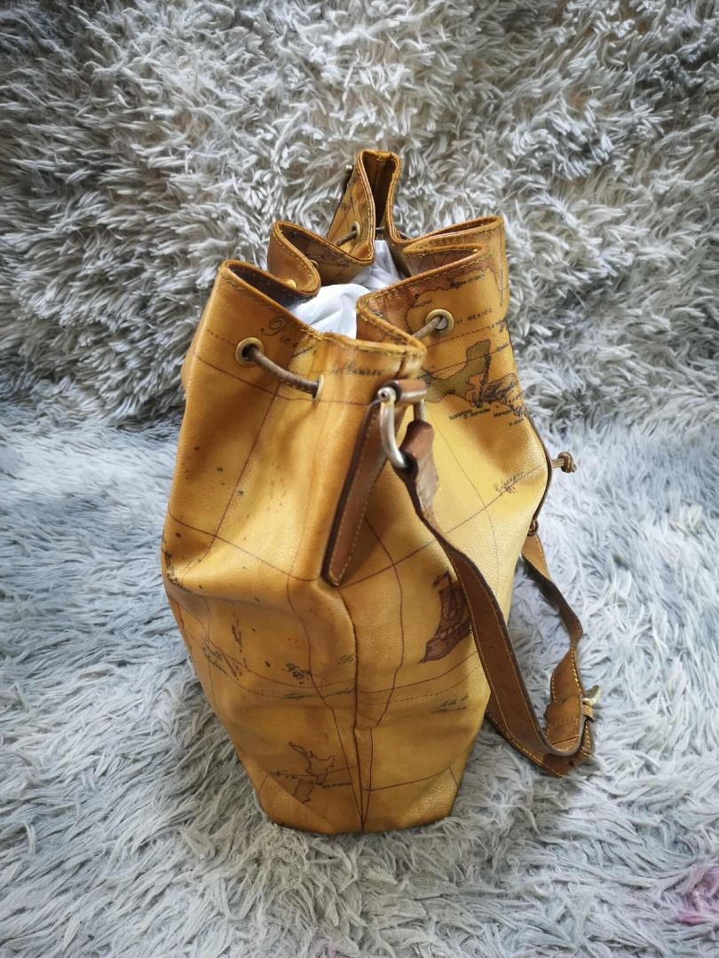 Tan Brown Vintage World Map Print Drawstring Bucket Bag (Category: Cross-body Bags) located in Santa Cruz. Submitted by jmy_surplus.2 (Listing ID 1471016164, Image 2). Description: Color: Tan Brown / Camel Brown Type/Kind: Bucket Bag / Crossbody Bag / Shoulder Bag Material: Body: Coated Canvas / Synthetic Leather (estimated) Strap & Trim: Leather-Look Material Lining: Fabric Hardware: Antique Gold-Tone Metal Style: Vintage Classic Retro Casual Tr