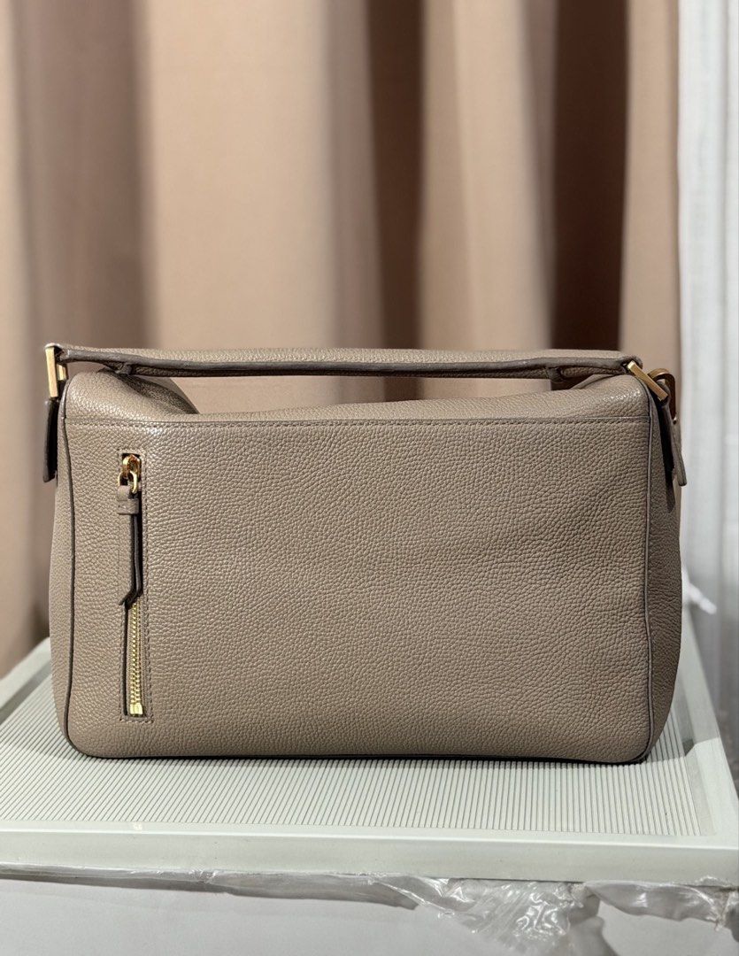 Taupe Leather Shoulder Bag With Gold Hardware (Category: Luxury Bags & Wallets) located in Pasay City. Submitted by maviemavz (Listing ID 1471009256, Image 3). Description: - Color & Material: Taupe textured pebble grain leather - Hardware: Sleek gold-tone accents - Strap: Detachable matching leather strap included - Closure & Pockets: Secure top zip closure with an exterior side zip pocket - Interior: Very spacious compartments with a clean, str