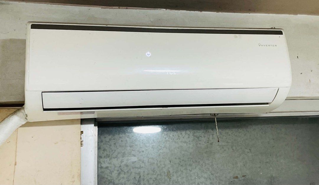 TCL Inverter Wall-Mounted Air Conditioner Unit (Category: Other Home Furniture) located in Manila. Submitted by swiftwolf.dcf445 (Listing ID 1470964697, Image 1). Description: - Brand: TCL Wall-Mounted Inverter Air Conditioner - Color: Clean white finish with illuminated power button and brand logo - Performance: Fast cooling and super quiet operation - Condition: Standard split unit setup installed above a window frame - Logistics: Buyer handles