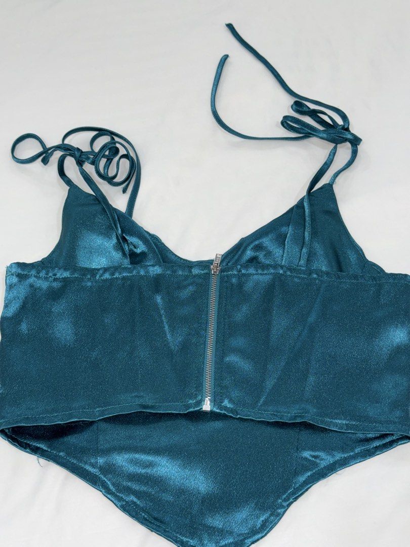 Teal Satin Corset Crop Top with Straps (Category: Sleeveless) located in San Mateo. Submitted by cheeetosjalapeno (Listing ID 1471005916, Image 2). Description: ✨DECLUTTERING SALE✨ Condition: USED ONCE Location: San Mateo, Rizal - Color: Stunning teal - Material: Smooth, shiny satin fabric that catches the light - Design: Structured boning through the front with a flattering pointed hemline - Straps: Sleeveless with adjustable spaghetti straps - 