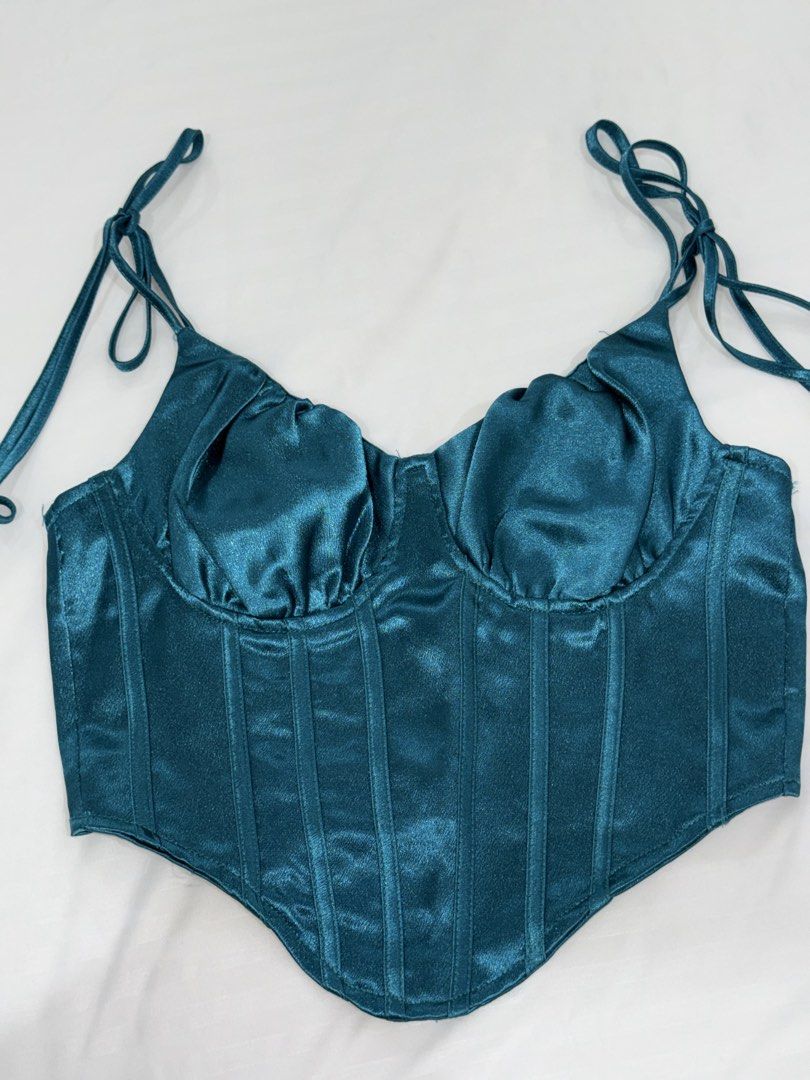 Teal Satin Corset Crop Top with Straps (Category: Sleeveless) located in San Mateo. Submitted by cheeetosjalapeno (Listing ID 1471005916, Image 1). Description: ✨DECLUTTERING SALE✨ Condition: USED ONCE Location: San Mateo, Rizal - Color: Stunning teal - Material: Smooth, shiny satin fabric that catches the light - Design: Structured boning through the front with a flattering pointed hemline - Straps: Sleeveless with adjustable spaghetti straps - 