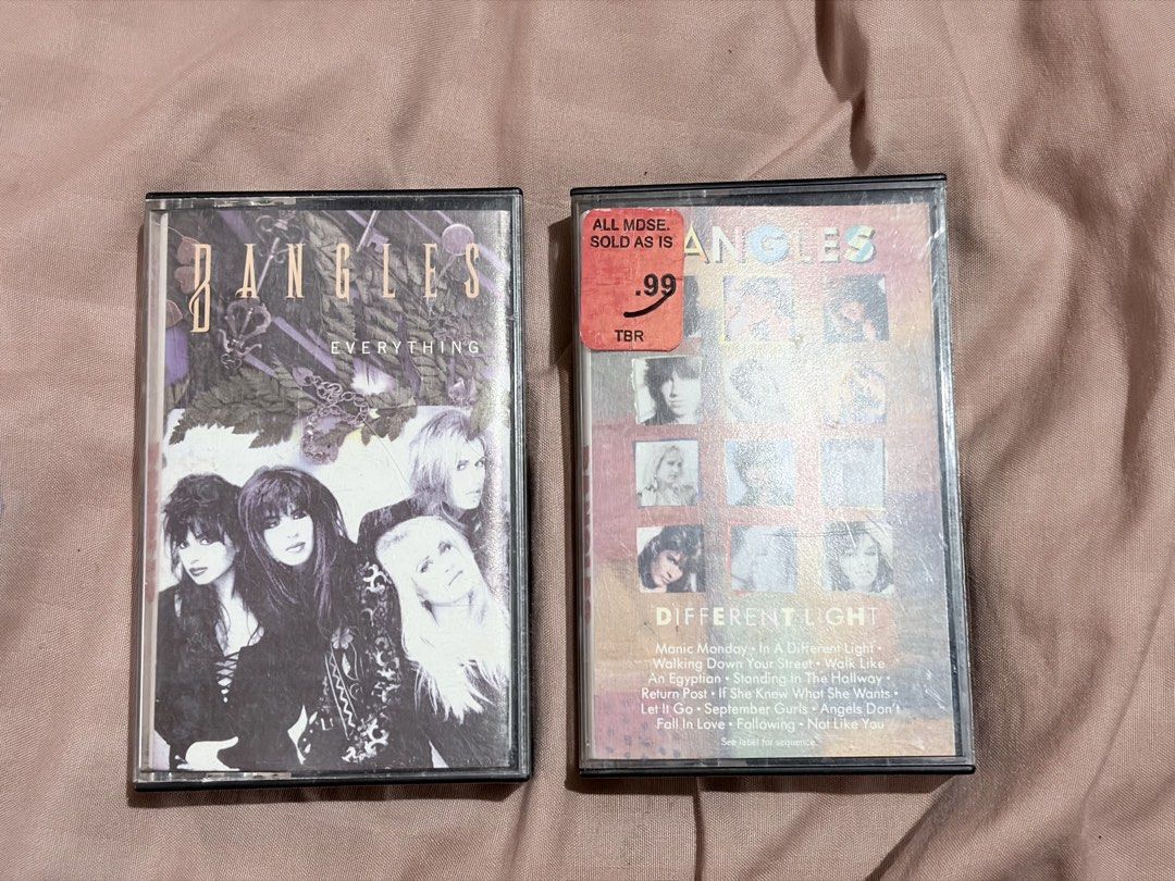 The Bangles Cassette Tapes Everything and Different Light As Lot (Category: CDs & DVDs) located in Tabaco. Submitted by cinemahilig (Listing ID 1470979005, Image 1). Description: - Set of 2 classic cassette albums by The Bangles: Everything and Different Light - Comes in standard plastic cases - Note: Different Light has an authentic old store clearance sticker on the front - Features iconic hits including Manic Monday and Walk Like An Egyptian -