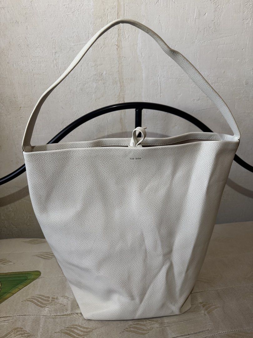 The Row Off-White Leather Shoulder Bag (Category: Shoulder Bags) located in Danao, Cebu. Submitted by jojie.1983 (Listing ID 1470980941, Image 1). Description: -Thrift Source and it has dirt inside pl see details photo - Brand: The Row made in Italy -Size: Large - Material: Premium off-white pebbled leather - Design: bucket shoulder bag - Handle: Single top handle for easy shoulder wear - Closure: Secure interior tie closure at the top - Details: