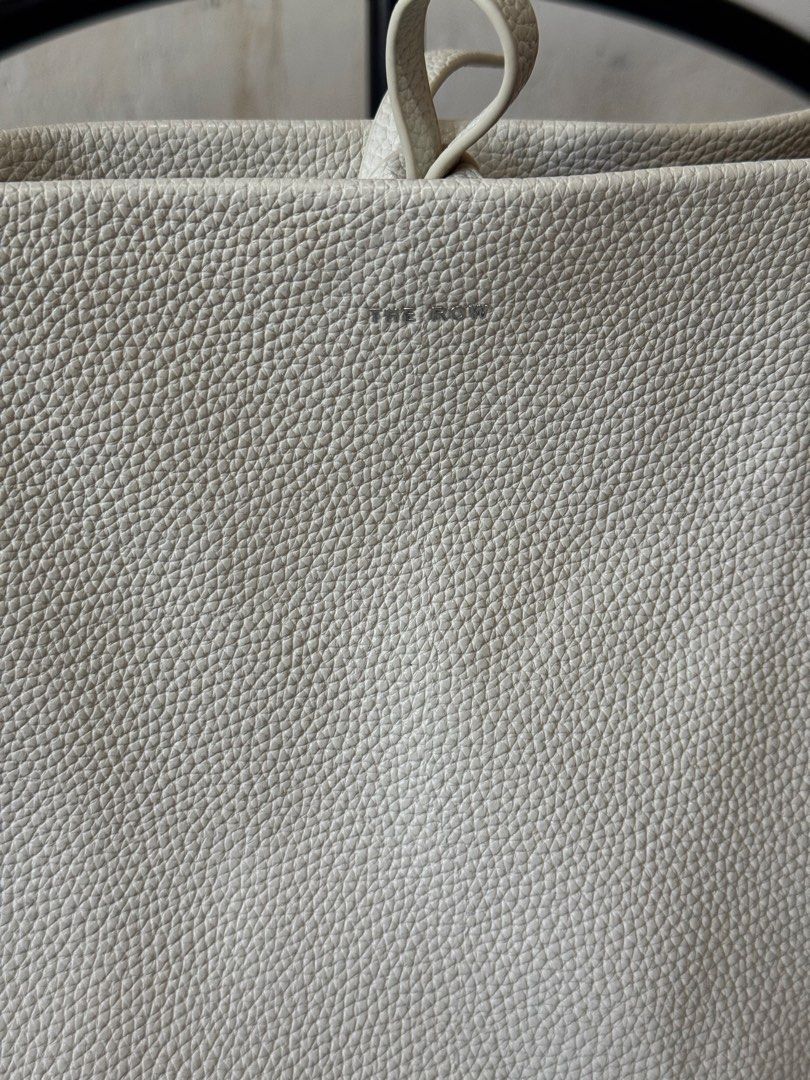 The Row Off-White Leather Shoulder Bag (Category: Shoulder Bags) located in Danao, Cebu. Submitted by jojie.1983 (Listing ID 1470980941, Image 3). Description: -Thrift Source and it has dirt inside pl see details photo - Brand: The Row made in Italy -Size: Large - Material: Premium off-white pebbled leather - Design: bucket shoulder bag - Handle: Single top handle for easy shoulder wear - Closure: Secure interior tie closure at the top - Details: