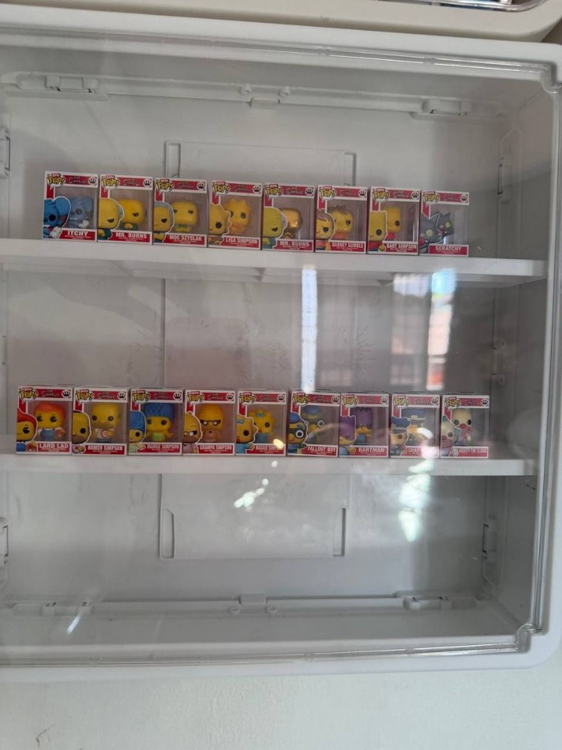 The Simpsons Figures Collection Bitty POP (Category: Designer & Blind Box Toys) located in Caloocan City. Submitted by silentdragon_931b8a (Listing ID 1470995534, Image 1). Description: - Complete set of The Simpsons Funko Pocket Pop figures - Includes favorite characters like Bart, Lisa, Mr. Burns, Moe, Itchy, Scratchy, and more - Comes with original mini boxes for each figure - Includes a clear, wall-mounted display case to prevent dust - Ready