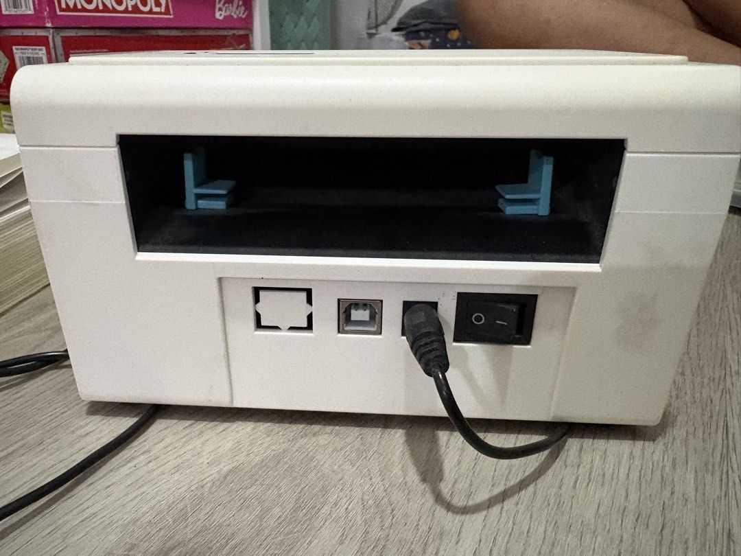 Thermal Label Printer with Stacked Paper Tray (Category: Printers, Scanners & Copiers) located in Manila. Submitted by ruizaaa (Listing ID 1470960017, Image 3). Description: - White thermal label printer, clean and ready for setup - Perfect for printing shipping labels and stickers - Includes power cable and power adapter - Comes with an external holder and a stack of blank fanfold labels - Rear ports: Power switch, power port, USB port, and netw