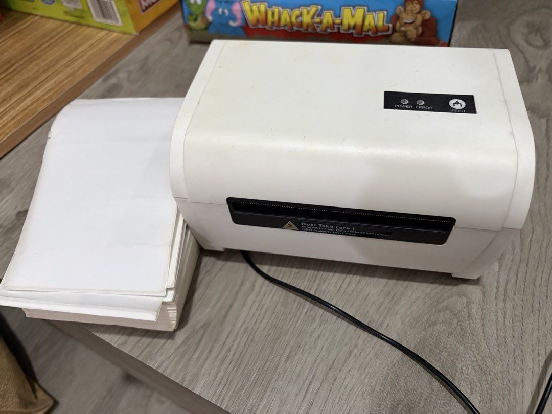Thermal Label Printer with Stacked Paper Tray (Category: Printers, Scanners & Copiers) located in Manila. Submitted by ruizaaa (Listing ID 1470960017, Image 2). Description: - White thermal label printer, clean and ready for setup - Perfect for printing shipping labels and stickers - Includes power cable and power adapter - Comes with an external holder and a stack of blank fanfold labels - Rear ports: Power switch, power port, USB port, and netw