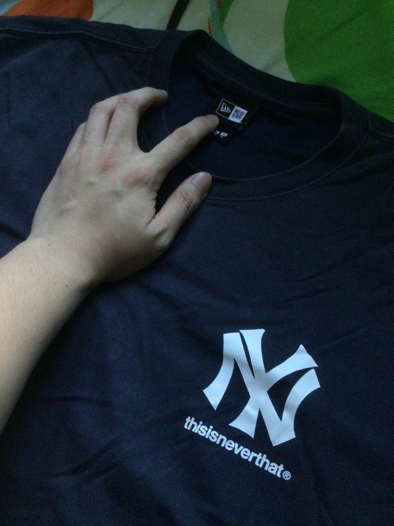thisisneverthat x New Era Shirt (Category: Tshirts & Polo Shirts ) located in General Trias. Submitted by dunht (Listing ID 1471080712, Image 2). Description: - Brand/Collab: thisisneverthat x New Era - Design: New York Yankees Cooperstown logo on front, embroidered New Era flag on left sleeve - Color: Navy Blue - Size: 110 (XXL) - Fit: Regular fit crewneck - Material: Heavy cotton - Condition: Clean piece.