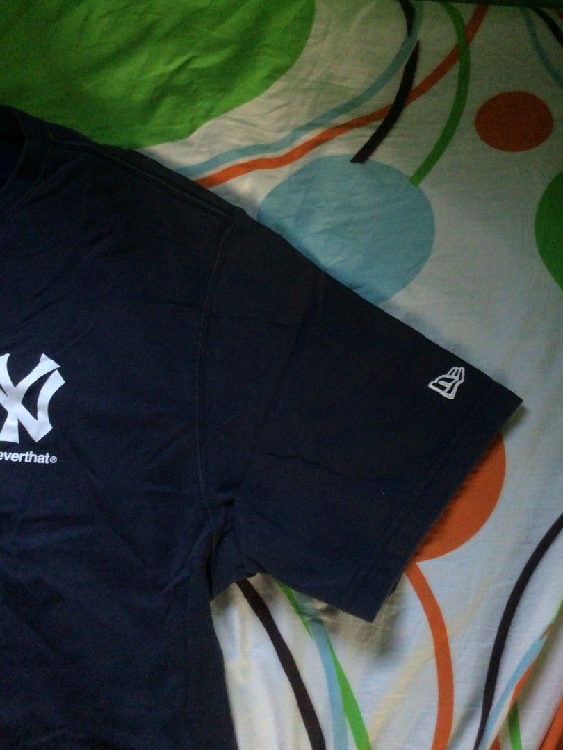 thisisneverthat x New Era Shirt (Category: Tshirts & Polo Shirts ) located in General Trias. Submitted by dunht (Listing ID 1471080712, Image 3). Description: - Brand/Collab: thisisneverthat x New Era - Design: New York Yankees Cooperstown logo on front, embroidered New Era flag on left sleeve - Color: Navy Blue - Size: 110 (XXL) - Fit: Regular fit crewneck - Material: Heavy cotton - Condition: Clean piece.