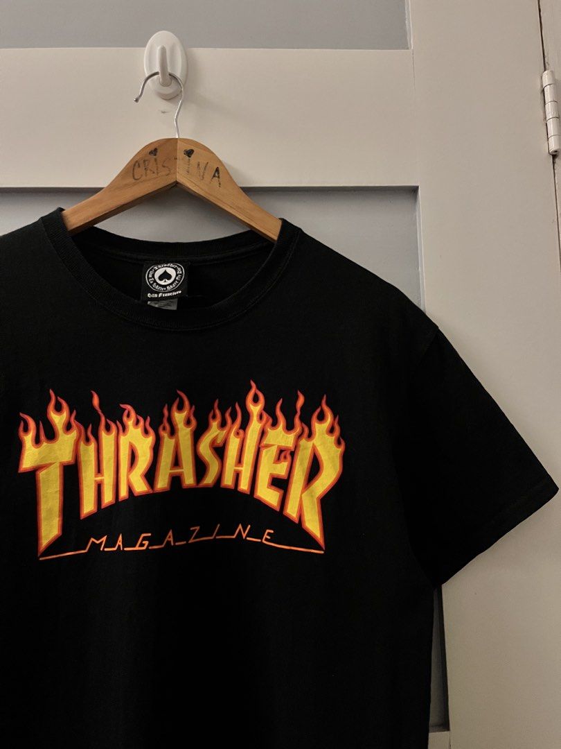 Thrasher Magazine Flame Logo T-shirt Black (Category: Tshirts & Polo Shirts ) located in Calasiao. Submitted by cristinabarongan5 (Listing ID 1471059708, Image 2). Description: Thrasher Magazine t-shirt in classic black. Iconic flame logo graphic printed across the chest in bright yellow and orange. Crew neck, short sleeves. Standard fit. Tagged size medium. 100 percent cotton, made in Dominican Republic. - Dimension 20 x 27.