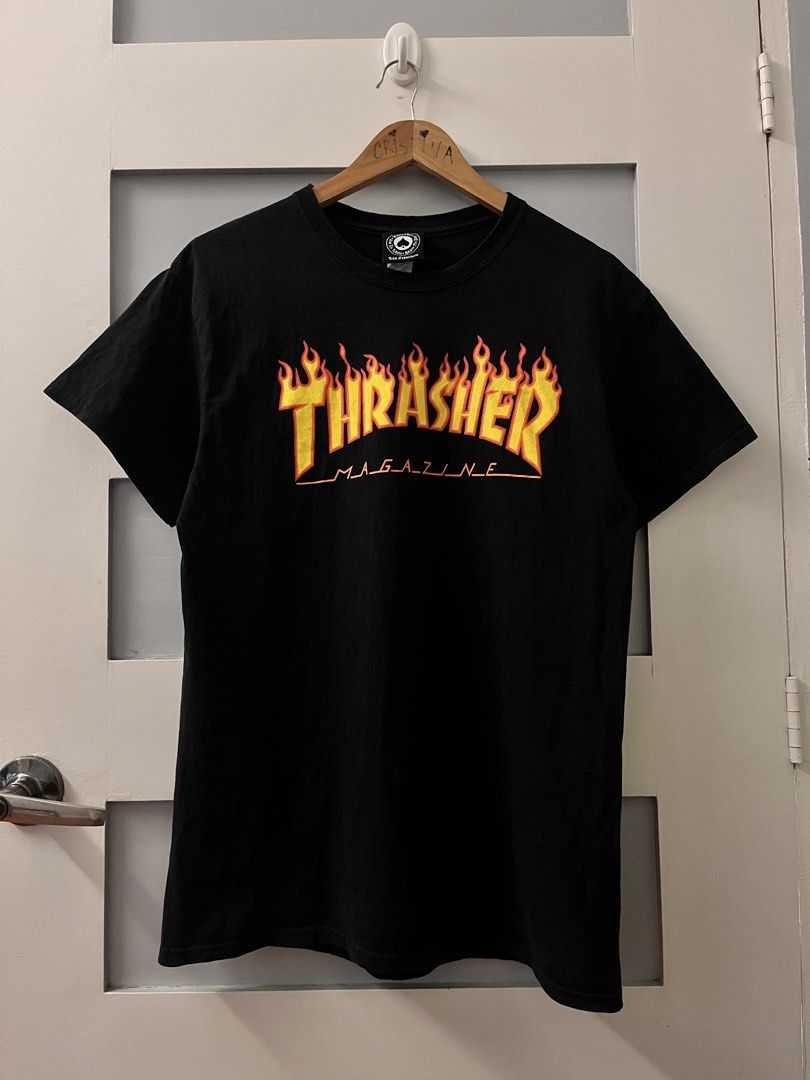 Thrasher Magazine Flame Logo T-shirt Black (Category: Tshirts & Polo Shirts ) located in Calasiao. Submitted by cristinabarongan5 (Listing ID 1471059708, Image 1). Description: Thrasher Magazine t-shirt in classic black. Iconic flame logo graphic printed across the chest in bright yellow and orange. Crew neck, short sleeves. Standard fit. Tagged size medium. 100 percent cotton, made in Dominican Republic. - Dimension 20 x 27.