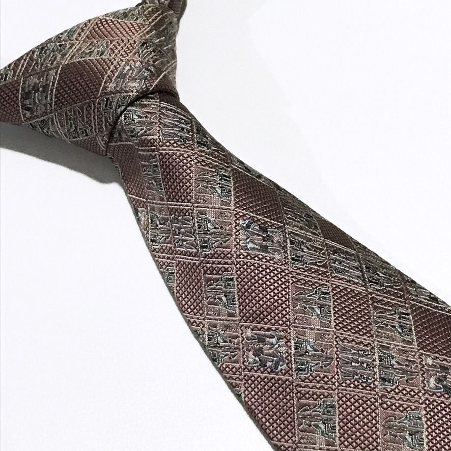 Tie Workshop Jacquard Hieroglyphs Pattern Dusty Rose Neck Tie (Category: Ties) located in Taguig. Submitted by retrogaze (Listing ID 1471097493, Image 1). Description: This vintage 100% silk necktie by High Class Tie Workshop (ネクタイ工房) features a dusty rose base woven with a rich, tactile diamond-mesh grid texture. The blade is styled in a repeating geometric grid displaying tonal jacquard-woven Egyptian hieroglyph motifs in subtle sage green, met