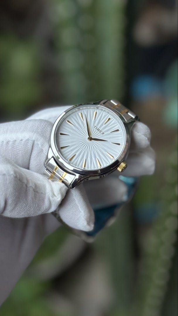 Timex Two-Tone Watch TW2V06500 (Category: Women's Watches) located in Manila. Submitted by junjun12356 (Listing ID 1471074935, Image 3). Description: - Brand: Timex - Style: Two-tone women's watch (silver and gold bracelet links) - Dial: Textured white sunburst dial with elegant gold-tone markers and crown - Movement: Reliable quartz movement, keeps time properly - Condition: Excellent, with protective plastic wrapping still on parts of the clasp