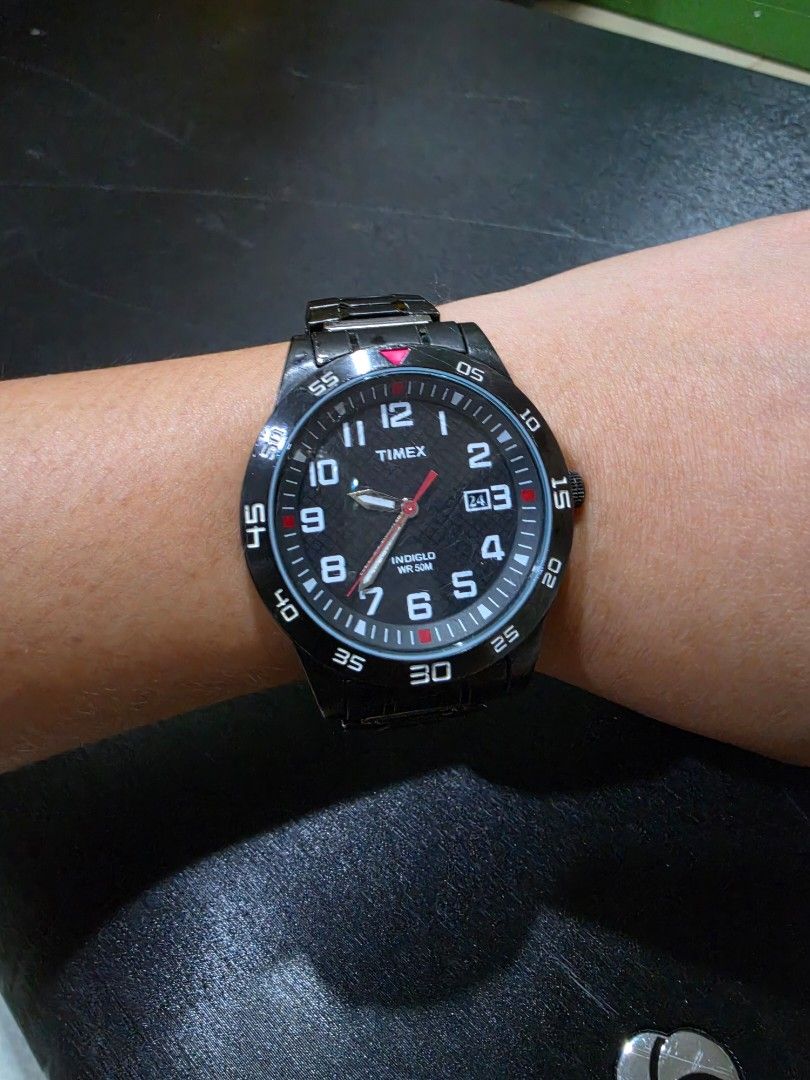 Timex Watch (Category: Luxury Watches) located in Iloilo. Submitted by floresse (Listing ID 1471073322, Image 1). Description: TW2P61600 - Authentic Timex Fieldstone Way Men's Watch Gunmetal / Black ion-plated stainless steel case and matching link Textured black dial featuring bold white Arabic numerals (1–12), a minute track with red accent markers, a date window positioned at the 3 o'clock mark, and red-tipped hands..