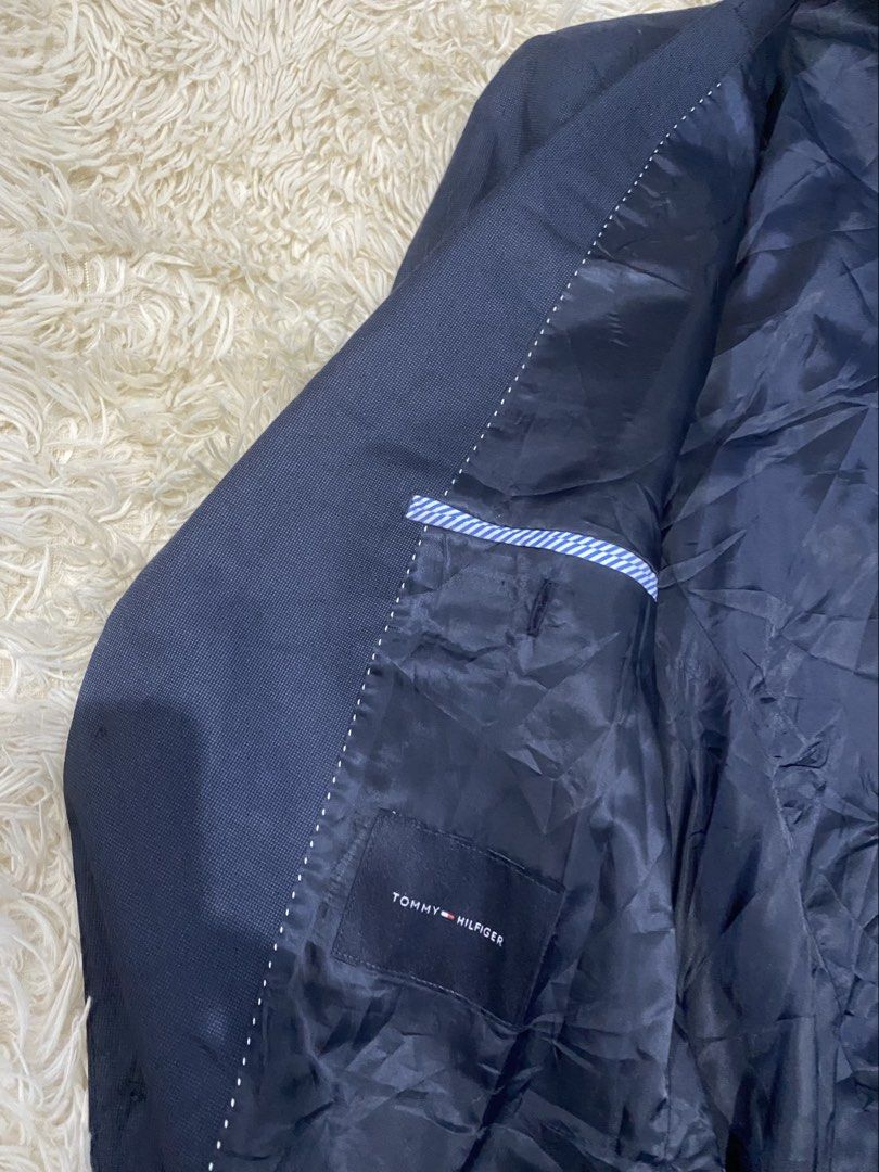 Tommy Hilfiger Navy Blue Suit Blazer Jacket (Category: Coats, Jackets and Outerwear) located in Antipolo. Submitted by switchneighborhood (Listing ID 1471043986, Image 3). Description: - Brand: Tommy Hilfiger - Color: Navy blue - Style: Classic tailored cut, two-button front closure, notched lapel - Details: Textured fabric construction, 4 buttons on each cuff, fully lined interior with multiple pockets and stylish contrasting striped trim - Cond