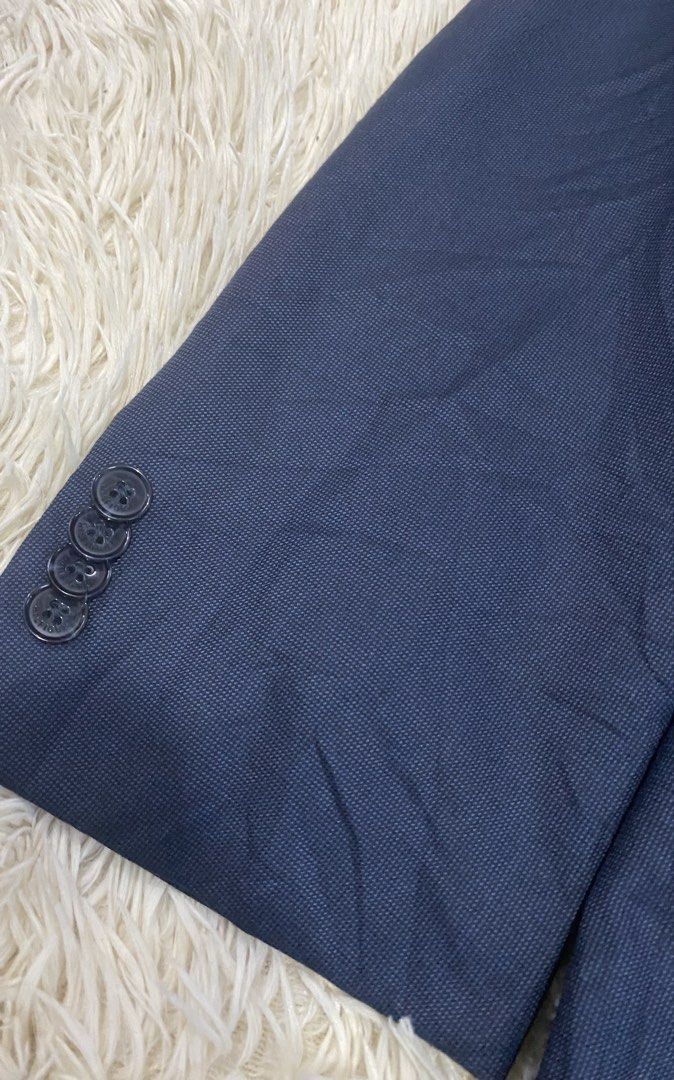 Tommy Hilfiger Navy Blue Suit Blazer Jacket (Category: Coats, Jackets and Outerwear) located in Antipolo. Submitted by switchneighborhood (Listing ID 1471043986, Image 2). Description: - Brand: Tommy Hilfiger - Color: Navy blue - Style: Classic tailored cut, two-button front closure, notched lapel - Details: Textured fabric construction, 4 buttons on each cuff, fully lined interior with multiple pockets and stylish contrasting striped trim - Cond