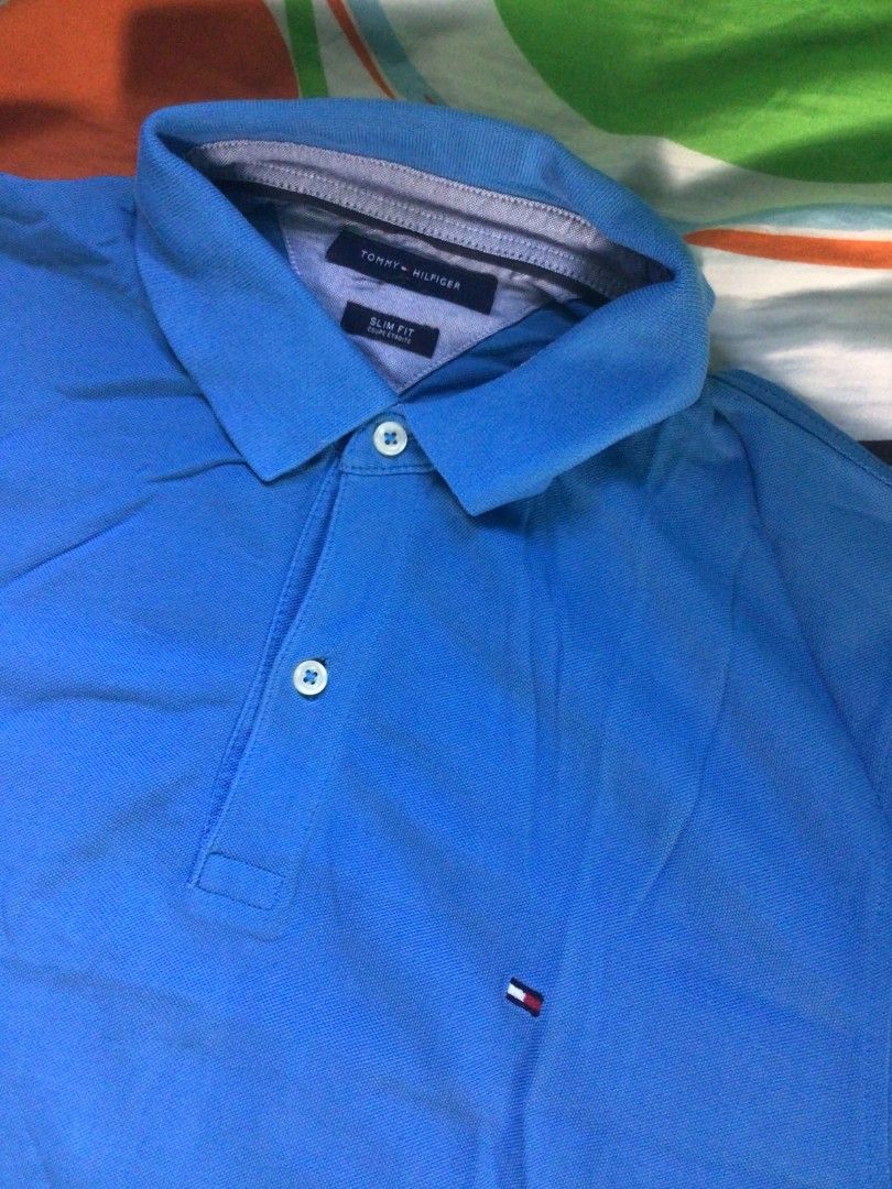 Tommy Hilfiger Polo Shirt (Category: Tshirts & Polo Shirts ) located in General Trias. Submitted by dunht (Listing ID 1471083023, Image 2). Description: - Brand: Tommy Hilfiger - Color: Bright Blue - Fit: Slim Fit - Material: Classic cotton pique fabric - Details: Collar, button placket, and small embroidered flag logo on the left chest - Condition/Extras: Clean cuffs and hem, includes original interior tag and spare button attached to the care l