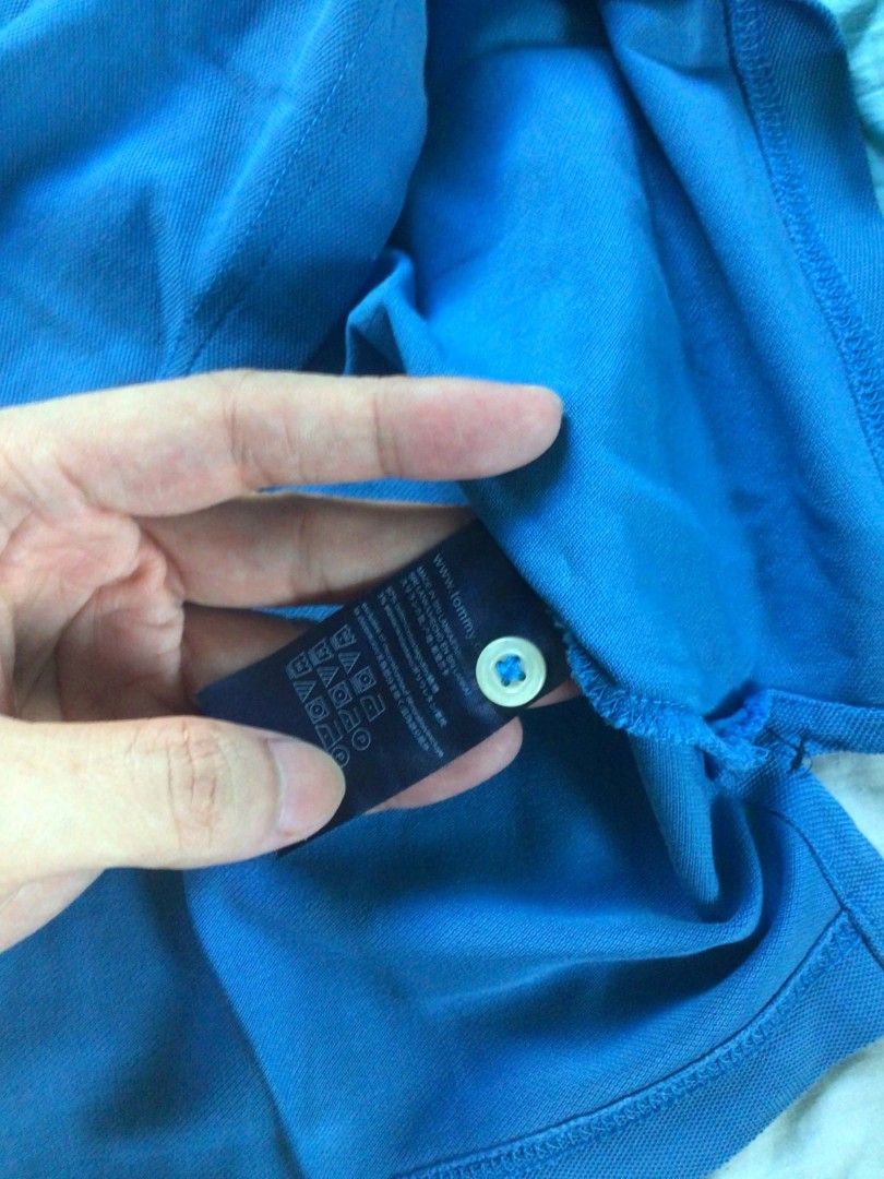 Tommy Hilfiger Polo Shirt (Category: Tshirts & Polo Shirts ) located in General Trias. Submitted by dunht (Listing ID 1471083023, Image 3). Description: - Brand: Tommy Hilfiger - Color: Bright Blue - Fit: Slim Fit - Material: Classic cotton pique fabric - Details: Collar, button placket, and small embroidered flag logo on the left chest - Condition/Extras: Clean cuffs and hem, includes original interior tag and spare button attached to the care l