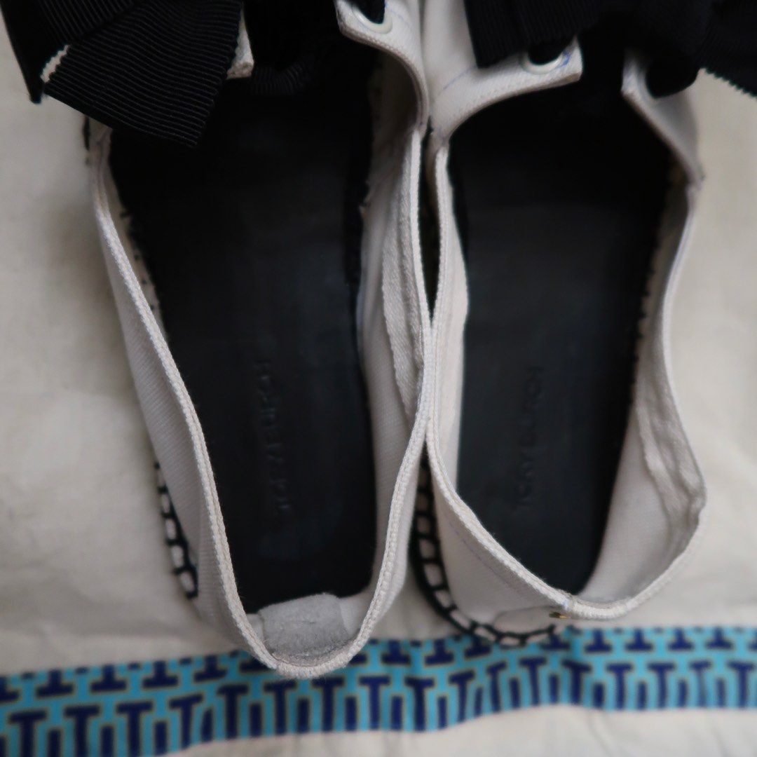 Tory Burch Canvas Bow Espadrilles White Black (Category: Flats & Sandals) located in Manila. Submitted by mixi_lexi (Listing ID 1471024888, Image 3). Description: - Brand: Tory Burch - Style: Slip-on canvas espadrilles - Color: Classic white and black with large black grosgrain bow - Origin: Made in Spain - Features: Black insole with debossed logo, stitched sole edge detail - Inclusions: Comes with original blue-bordered dust bag - Condition: Ex