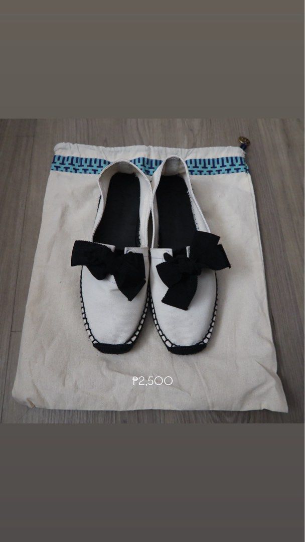 Tory Burch Canvas Bow Espadrilles White Black (Category: Flats & Sandals) located in Manila. Submitted by mixi_lexi (Listing ID 1471024888, Image 1). Description: - Brand: Tory Burch - Style: Slip-on canvas espadrilles - Color: Classic white and black with large black grosgrain bow - Origin: Made in Spain - Features: Black insole with debossed logo, stitched sole edge detail - Inclusions: Comes with original blue-bordered dust bag - Condition: Ex