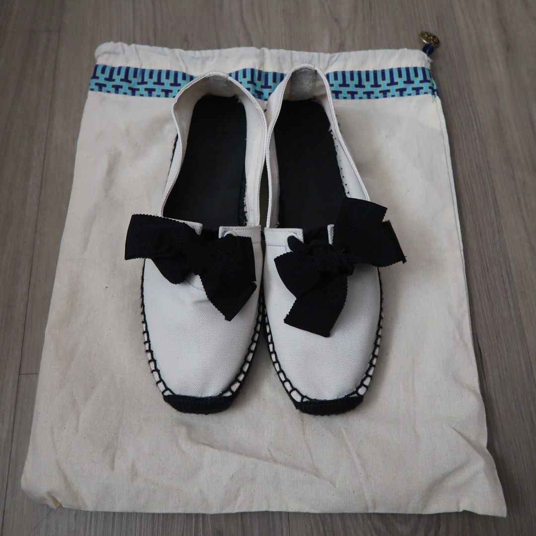 Tory Burch Canvas Bow Espadrilles White Black (Category: Flats & Sandals) located in Manila. Submitted by mixi_lexi (Listing ID 1471024888, Image 2). Description: - Brand: Tory Burch - Style: Slip-on canvas espadrilles - Color: Classic white and black with large black grosgrain bow - Origin: Made in Spain - Features: Black insole with debossed logo, stitched sole edge detail - Inclusions: Comes with original blue-bordered dust bag - Condition: Ex