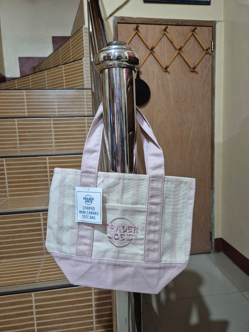 Trader Joe's Striped Mini Canvas Tote Bag (Category: Tote Bags) located in Gattaran. Submitted by uploadtounload (Listing ID 1470960212, Image 1). Description: - Brand new with original store tag attached - Authentic Trader Joe's mini canvas tote bag - Trendy pink and white striped pattern - Convenient front pocket with embroidered logo - Sturdy dual carrying handles - Handy compact size, ideal for daily errands and quick trips -Price for each.