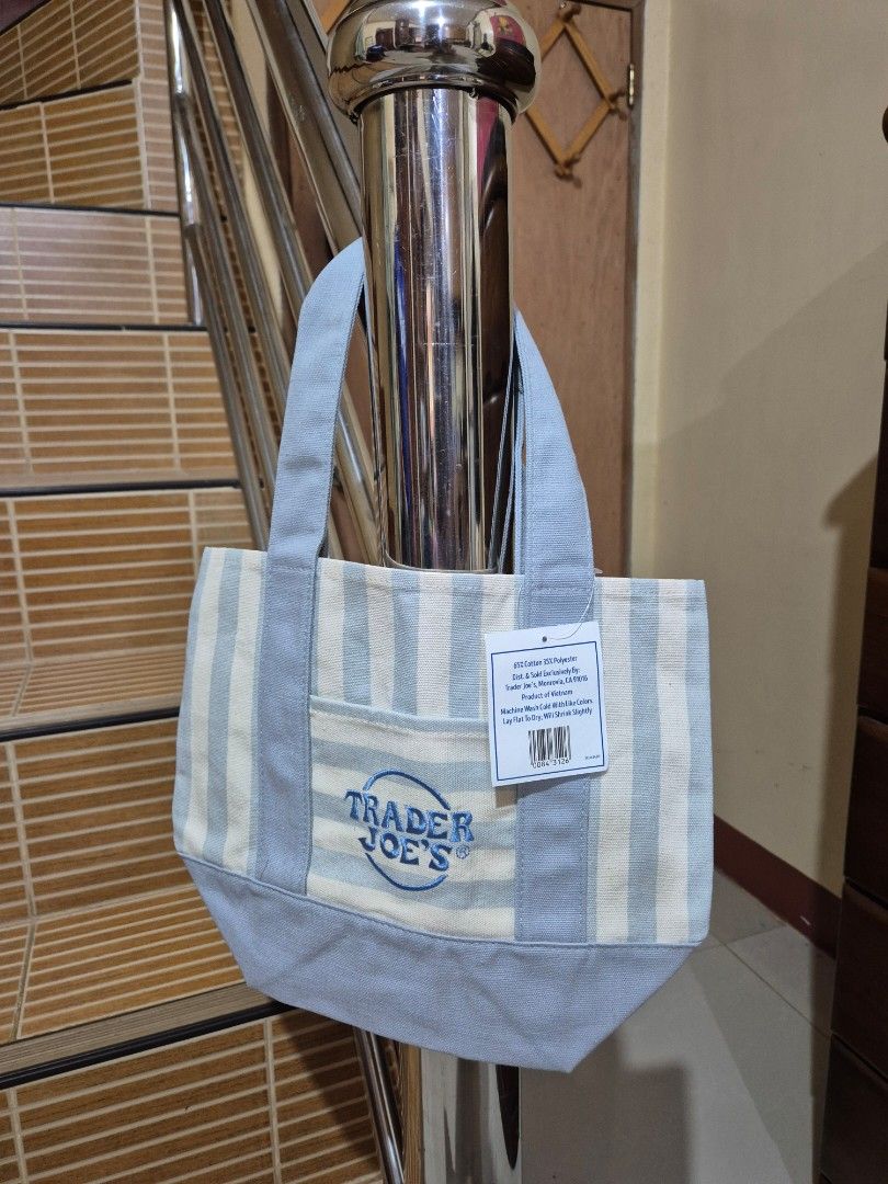 Trader Joe's Striped Mini Canvas Tote Bag (Category: Tote Bags) located in Gattaran. Submitted by uploadtounload (Listing ID 1470960212, Image 2). Description: - Brand new with original store tag attached - Authentic Trader Joe's mini canvas tote bag - Trendy pink and white striped pattern - Convenient front pocket with embroidered logo - Sturdy dual carrying handles - Handy compact size, ideal for daily errands and quick trips -Price for each.