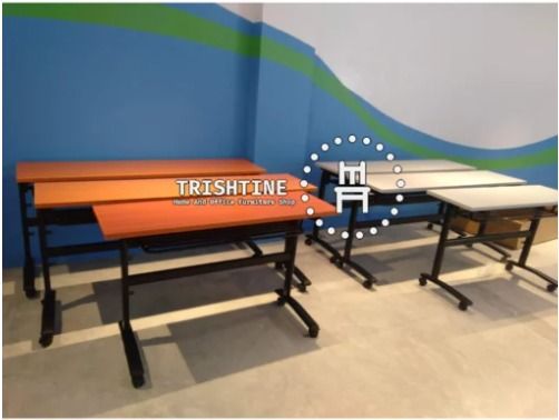 TRT-004 | Foldable Training Table with Caster Wheels (Category: Office Furniture & Fixtures) located in Caloocan City. Submitted by jim.trishtineofficefurnitures (Listing ID 1470986140, Image 1). Description: - Sturdy mobile training tables with smooth-rolling wheels - Space-saving foldable top design for easy storage - Durable black metal frames - Available finishes: Orange and Grey wood-grain - Ideal for classrooms, offices, and study areas DIS