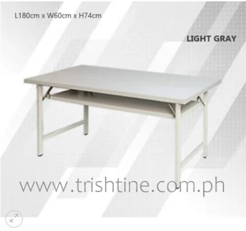 TRT-008 | Foldable Training Table (Category: Tables & Sets) located in Caloocan City. Submitted by jim.trishtineofficefurnitures (Listing ID 1470984838, Image 1). Description: - Color: Light gray - Dimensions: 180cm (L) x 60cm (W) x 74cm (H) - Frame: Sturdy metal - Storage: Includes a built-in lower shelf underneath the main surface - Portability: Folds completely flat for easy storage and transport - Versatile: Ideal for home office, studying, e