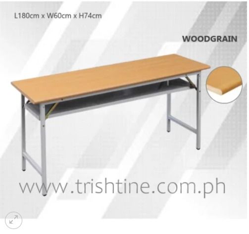 TRT-011 | Foldable Training Table Bullnose Edge (Category: Tables & Sets) located in Caloocan City. Submitted by jim.trishtineofficefurnitures (Listing ID 1470983729, Image 1). Description: - Dimensions: 180cm (L) x 60cm (W) x 74cm (H) - Design: Elegant woodgrain finish top with gray metal legs - Extra Storage: Built-in metal lower shelf for books and essentials - Durable: Sturdy steel frame construction for heavy-duty use - Space-Saving: Folds f