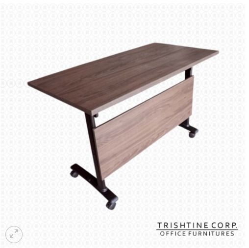 TRT-016 | Foldable Training Table (Category: Office Furniture & Fixtures) located in Caloocan City. Submitted by jim.trishtineofficefurnitures (Listing ID 1470982650, Image 1). Description: - Type: Wooden folding training table with modesty panel - Finish: Dark walnut top, black metal frame - Mobility: Smooth-rolling caster wheels for easy movement - Ideal for: Offices, study rooms, and training spaces - Features: Sturdy build and easy to store w